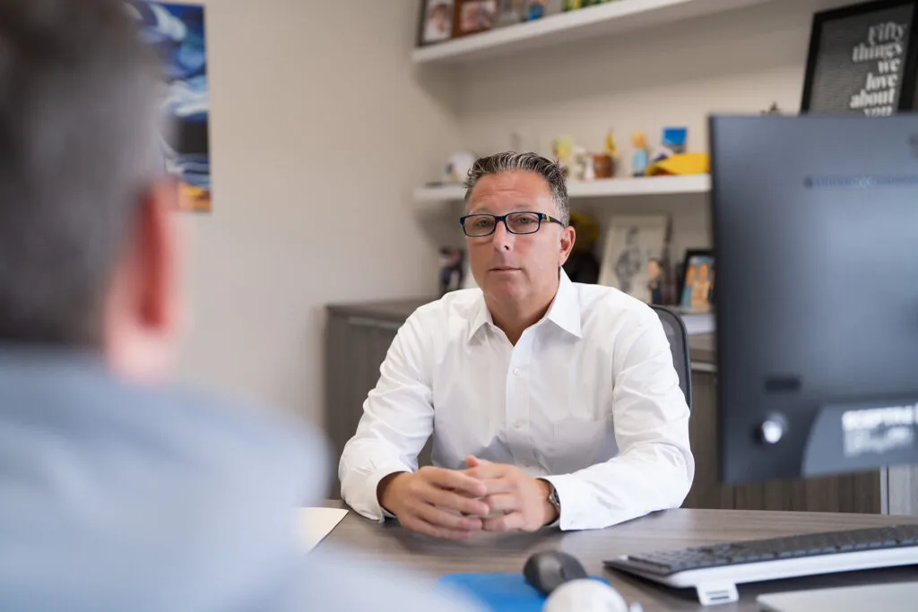 Mark Levin, ChFC®, CMFC®
Managing Partner talking to a client in his office in Marlton